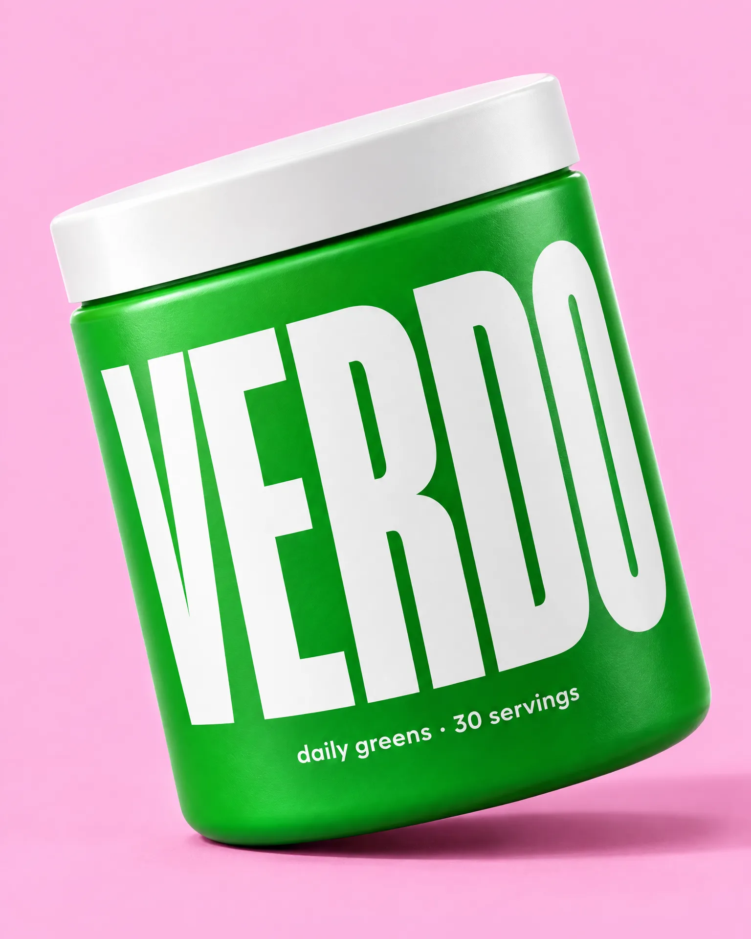 A bright green Verdo greens tub tilted on candy pink.