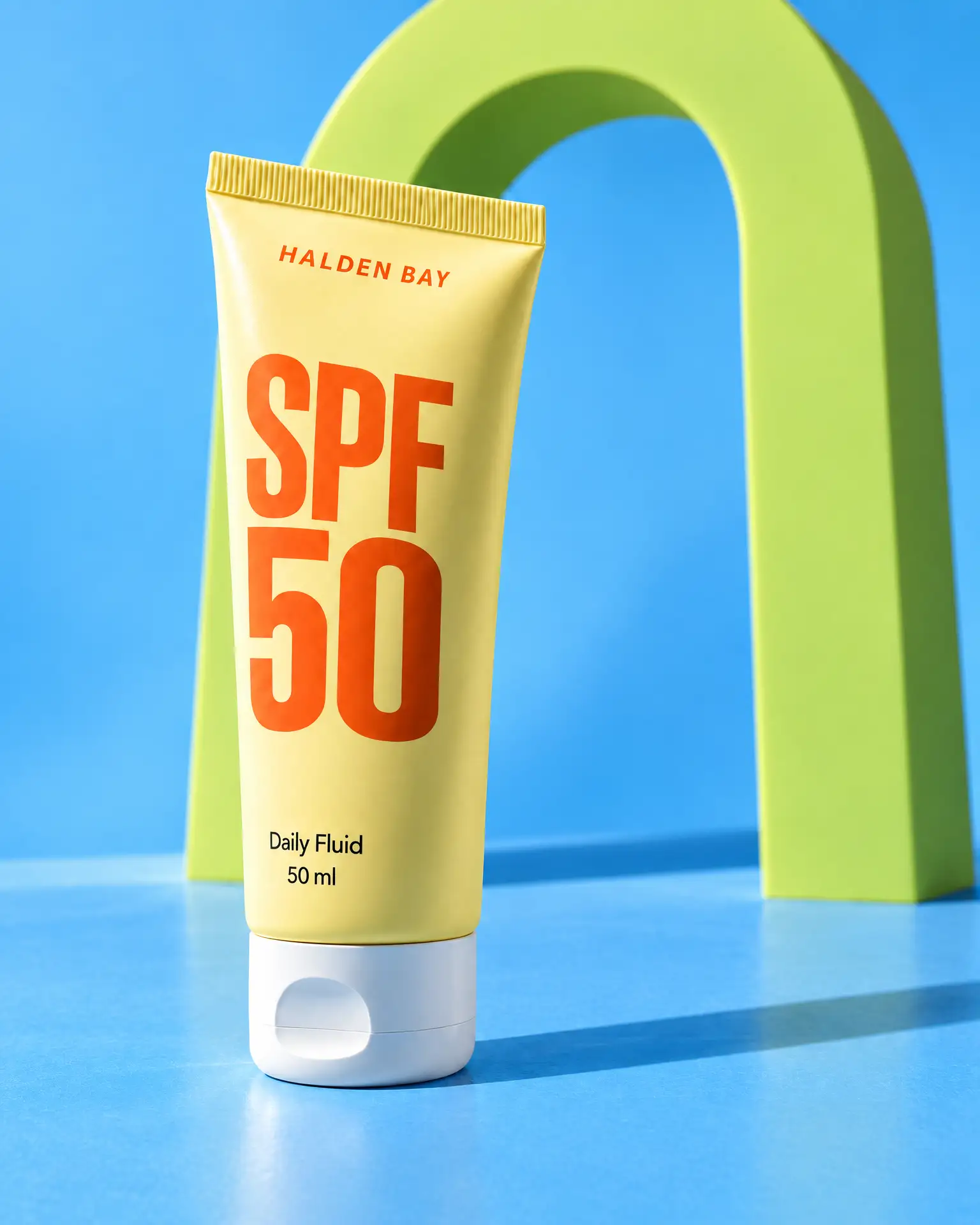 The yellow SPF 50 Fluid tube standing alone at Lime Arch, no one in the shot.